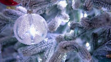 Close up of balls on christmas tree. Bokeh garlands in the background. New Year concept video