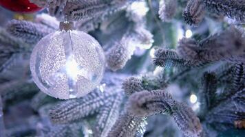 Close up of balls on christmas tree. Bokeh garlands in the background. New Year concept video