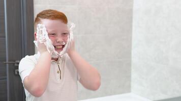 The boy smeared his cheeks with shaving foam video