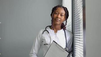 Portrait of confident skilled practitioner african american female physician video