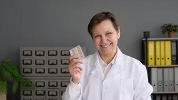 Portrait of a senior female doctor 50s with pills video