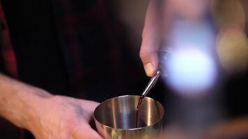 Making an alcoholic cocktail. The bartender pours a cocktail. video