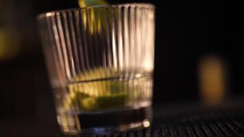 Bartender squeezing orange for cocktail video