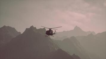 A helicopter is flying over a mountain range video