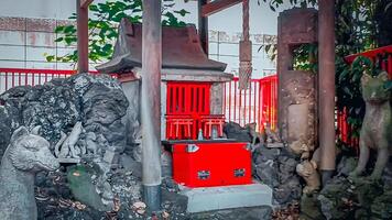 Small shrine and fox.Mimeguri Shrine is a shrine located in Mukojima, Sumida Ward, Tokyo, Japan. photo