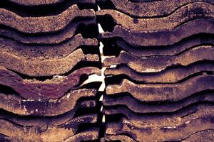 A pile of house tiles arranged parallel to each other. photo