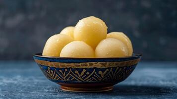 AI generated The rasgullas kept in a shallow bowl, dipped in sugar syrup.  Luxuious indian background. Plain deep navy blue background. Generated by artificial intelligence. photo