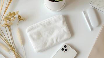 AI generated Top view of a white velvet pouch lies on a white desk, with an iPhone next to it. Generated by artificial intelligence. photo