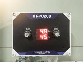 Installastion of Pressure control panel for controling fan exhaust in induatrial farm hatchery. photo