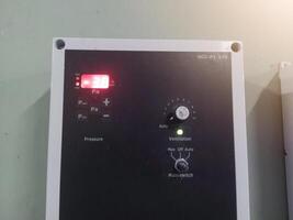 Installastion of Pressure control panel for controling fan exhaust in induatrial farm hatchery. photo