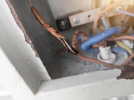 The panel's electrical cable melted due to overload. photo