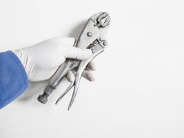 Man's hand holds a locking pliers isolated on white background. photo