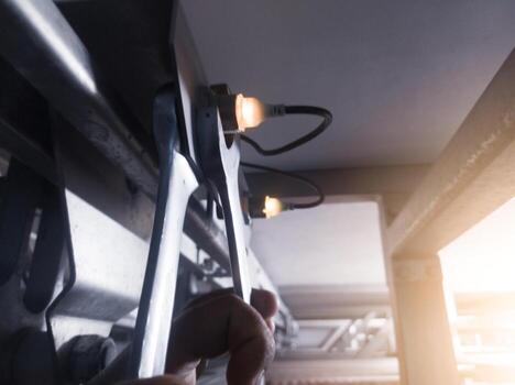 Check and adjusting the turning sensor on the incubation hatchering machine. Twchnician adjusting turning sensor with tools wrench. photo