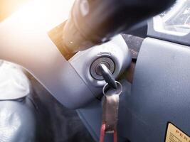 Key inserted into the lock of ignition switch of the vehicle truck. photo