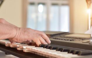 Close-up of Hands middle age man playing grand piano. photo