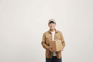 Asia delivery man smiling holding cardboard boxes, Delivery man over isolated gray background photo