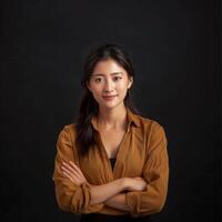 Young happy Asia woman looks in camera, business woman wearing brown t shirt smiling photo