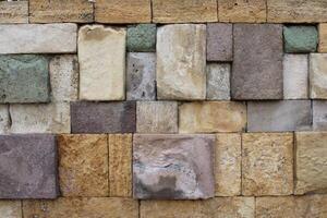Close-up view of a wall made of several colored natural stones. decor harmony vision. photo