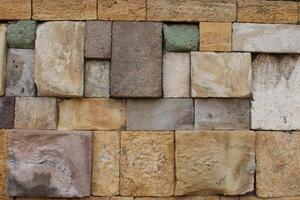 Close-up view of a wall made of several colored natural stones. decor harmony vision. photo