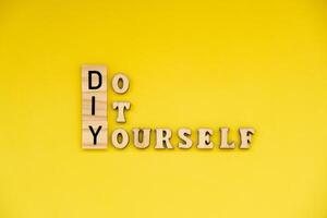 DIY Do It Yourself inscription on yellow background. Handmade home repair decorating handicraft. Tactile creative hobby concept me-made manual activities photo