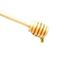 Wooden spoon honey isolated on white background photo