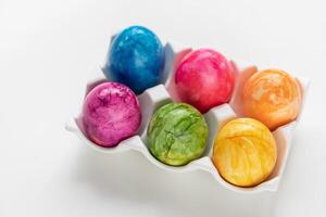 Assorted vibrant Easter eggs on white background, festive decoration photo
