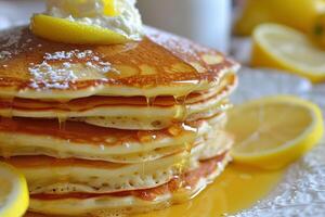 Stack of lemon ricotta pancakes stack with syrup and butter photo