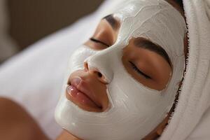 Black woman relaxing with green facial mask in spa setting photo