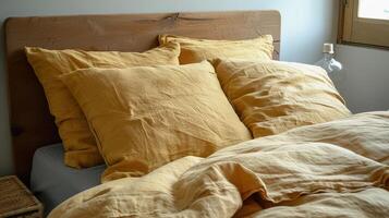 Warm morning light spills over bed dressed in yellow linen photo