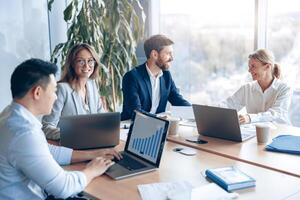 Creative business people working on project in modern office with panoramic view photo