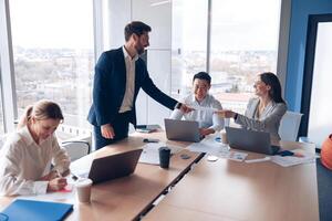 Creative business people working on new project in modern office with panoramic view photo