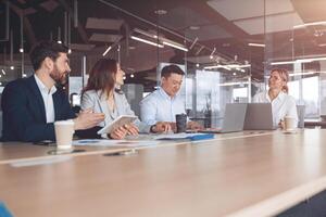 Confident and successful team. Group of modern people are working together in office photo