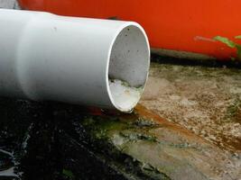 Photo of rainwater from pipes and floors on the top floor of an urban building