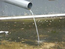 Photo of rainwater from pipes and floors on the top floor of an urban building