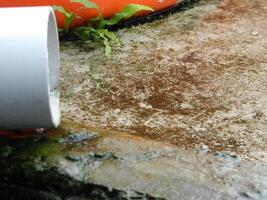 Photo of rainwater from pipes and floors on the top floor of an urban building