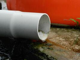 Photo of rainwater from pipes and floors on the top floor of an urban building