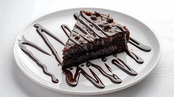 a piece of brownie cake with melted chocolate on a white plate on a white background photo