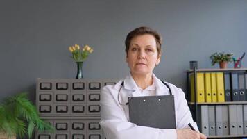 Portrait of a senior female doctor in her office video