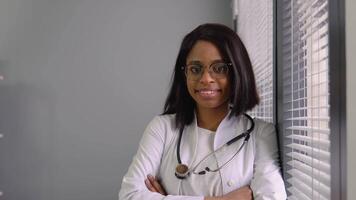 Portrait of confident skilled practitioner indian female physician in eyeglasses video