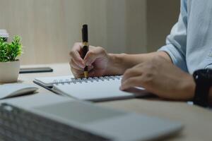 A professional writes in a notebook with focus and determination. photo