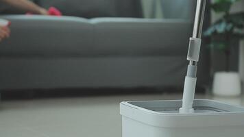 Woman cleaning table using rag and diffuser at home. video