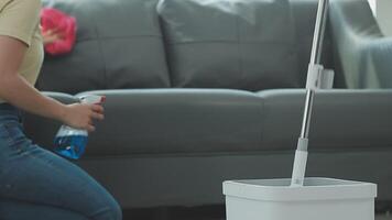 Woman cleaning table using rag and diffuser at home. video