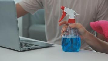 Woman cleaning table using rag and diffuser at home. video