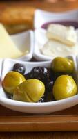 Collection of black and green olives with leaves. video