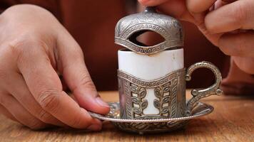 kvinna hand innehav en en kopp av turkiska kaffe på tabell video