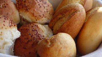 bread rolls rest in a black bowl on the table video