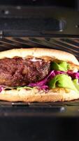 Sandwich with meatballs, lettuce, and red cabbage grilling at home video