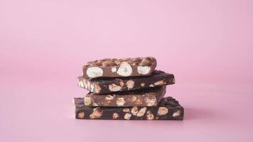 dark chocolate with mixed nut on black background video