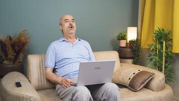 Man watching movie on laptop with happy expression. video