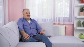 Emotional old man watching outside the window. video